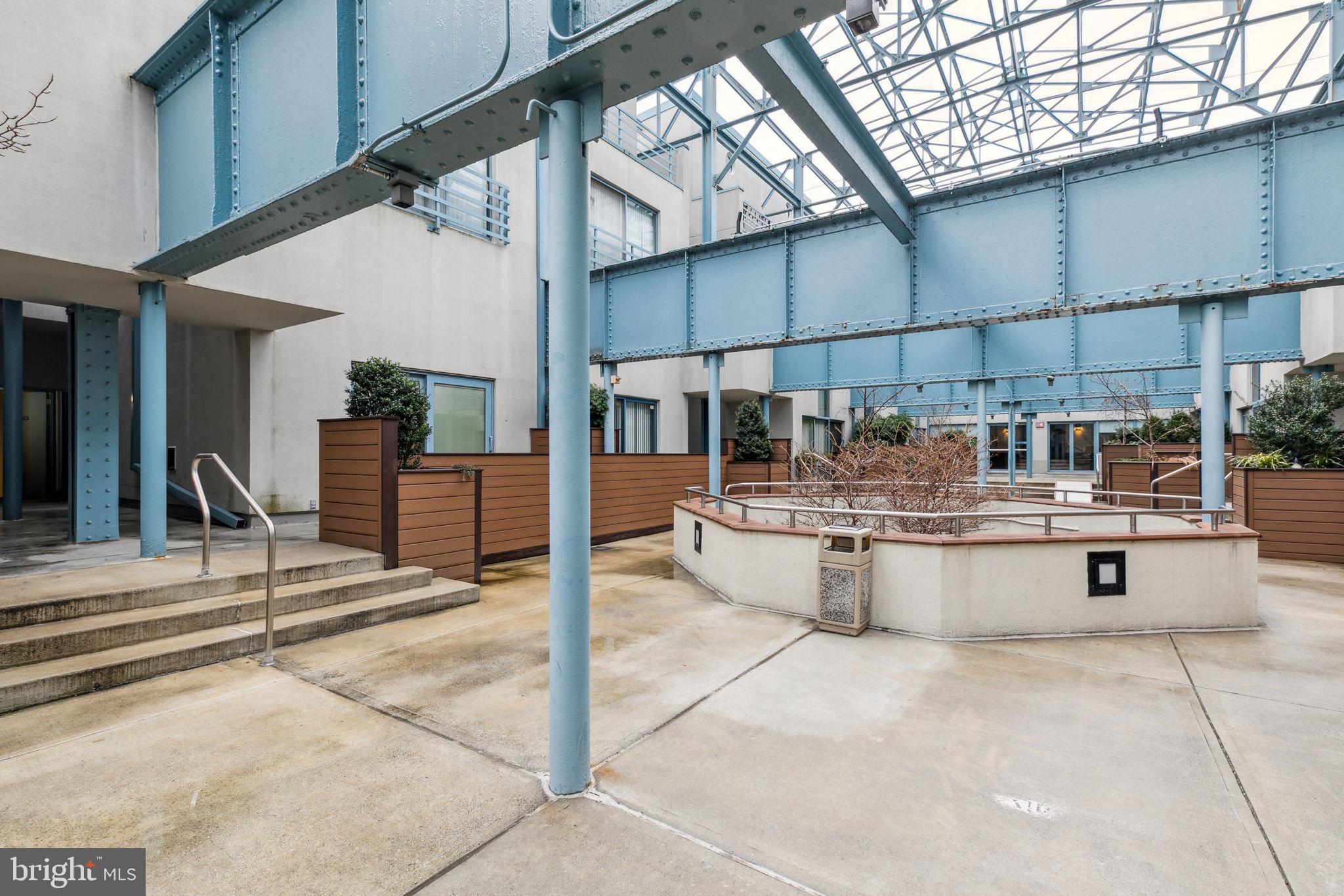 3 North Christopher Columbus Boulevard, Unit 405 Philadelphia, PA 19106 - Photo 18 of 20 a kitchen with stainless steel appliances kitchen island granite countertop a sink and cabinets