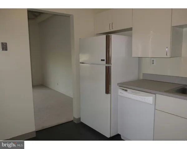 a kitchen with a refrigerator and a stove