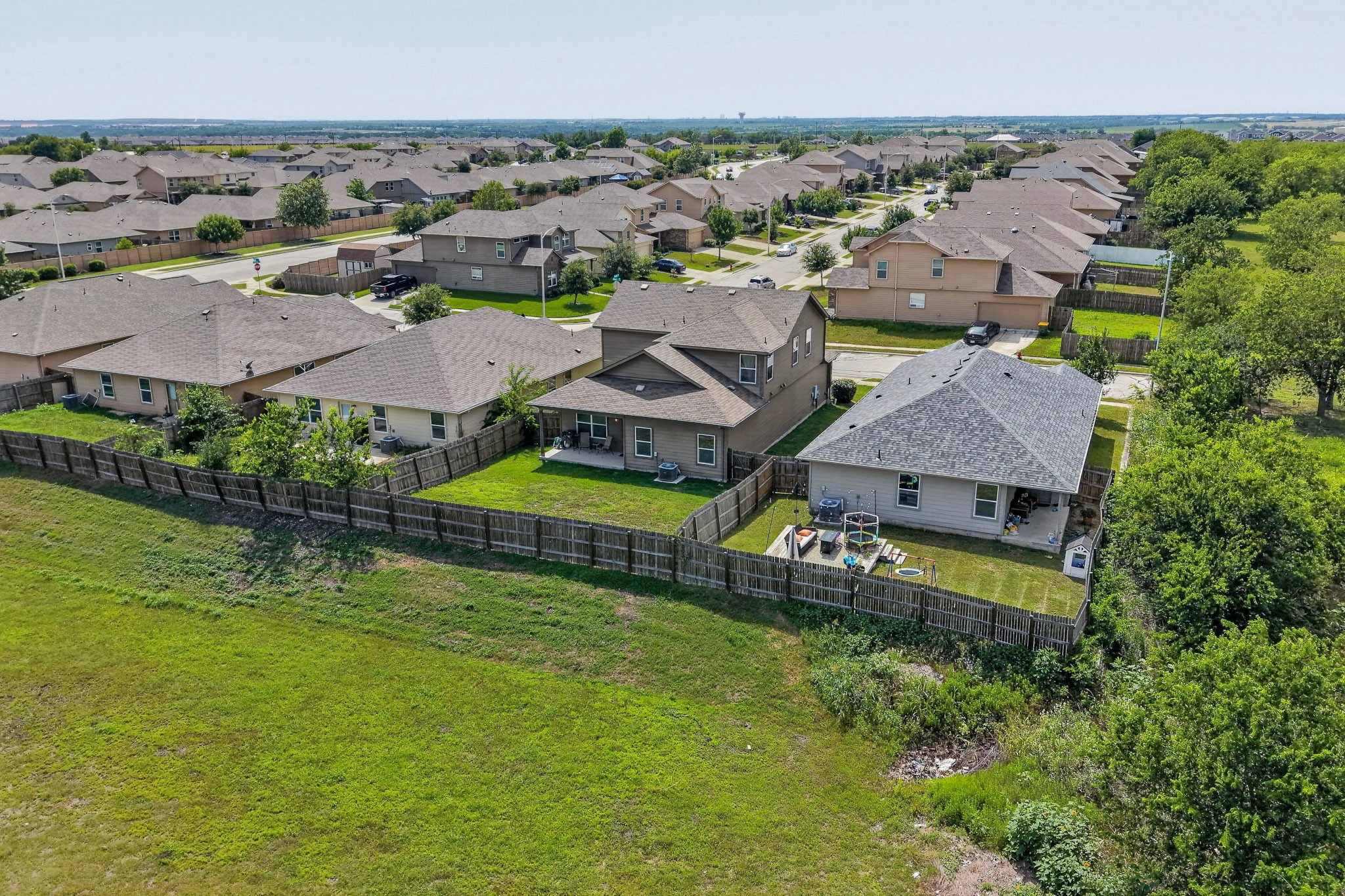 14513 Esker Road Manor, TX 78653 - Photo 35 of 38 An aerial perspective reveals a harmonious neighborhood layout, complete with manicured backyards and tree-lined streets.