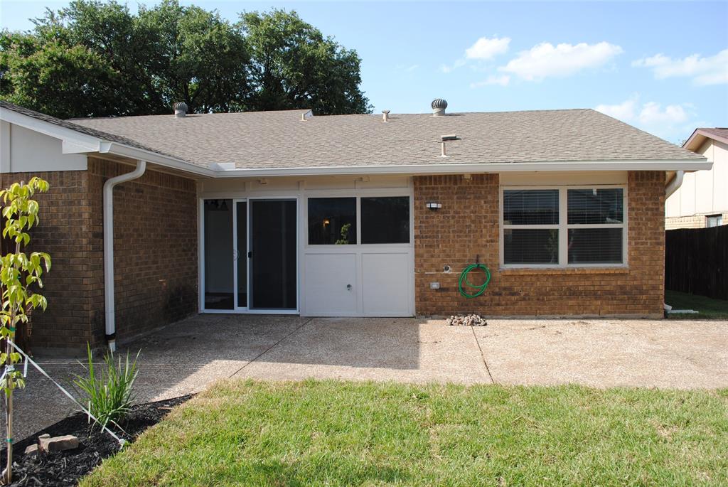 5241 Reed Drive The Colony, TX 75056 - Photo 23 of 26 Rear exterior featuring brick facade and a shingle roof