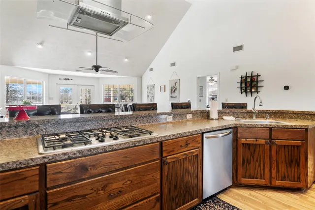 a kitchen with stainless steel appliances granite countertop a sink and cabinets