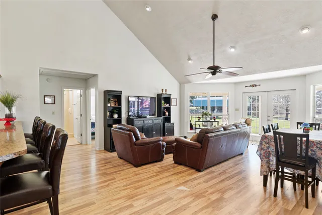 a living room with furniture fireplace and large windows