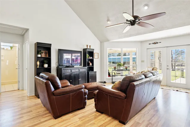 a living room with furniture and a flat screen tv with wooden floor