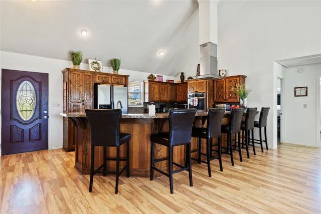 a dining room filled chandelier and wooden floor