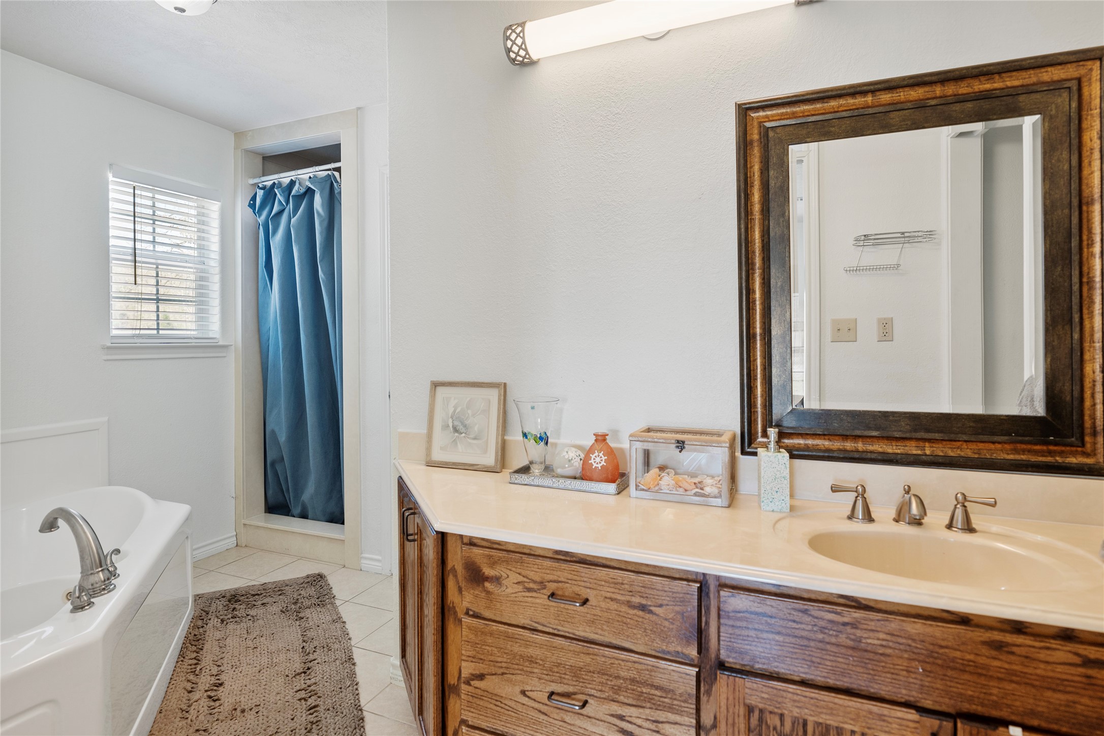 6776 Farm To Market Road 356 Trinity, TX 75862 - Photo 30 of 50 a en suite bathroom with a double vanity sink a mirror and a