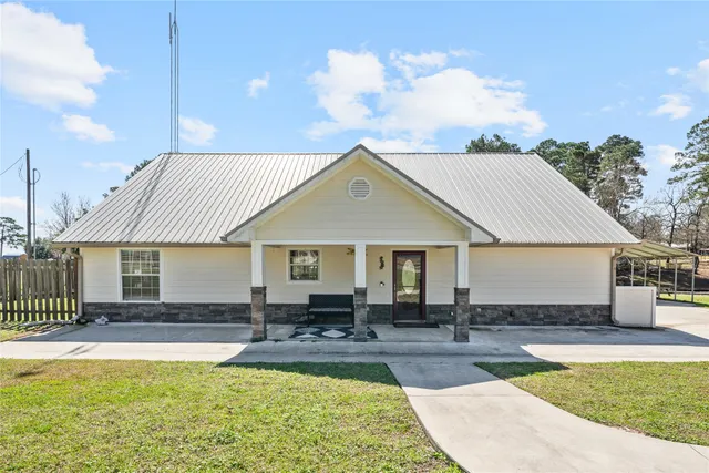 a view of a house with swimming pool and sitting area