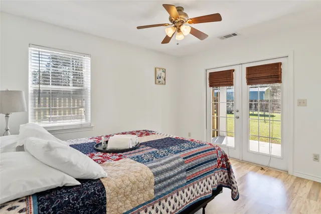 a bedroom with a bed and wooden floor