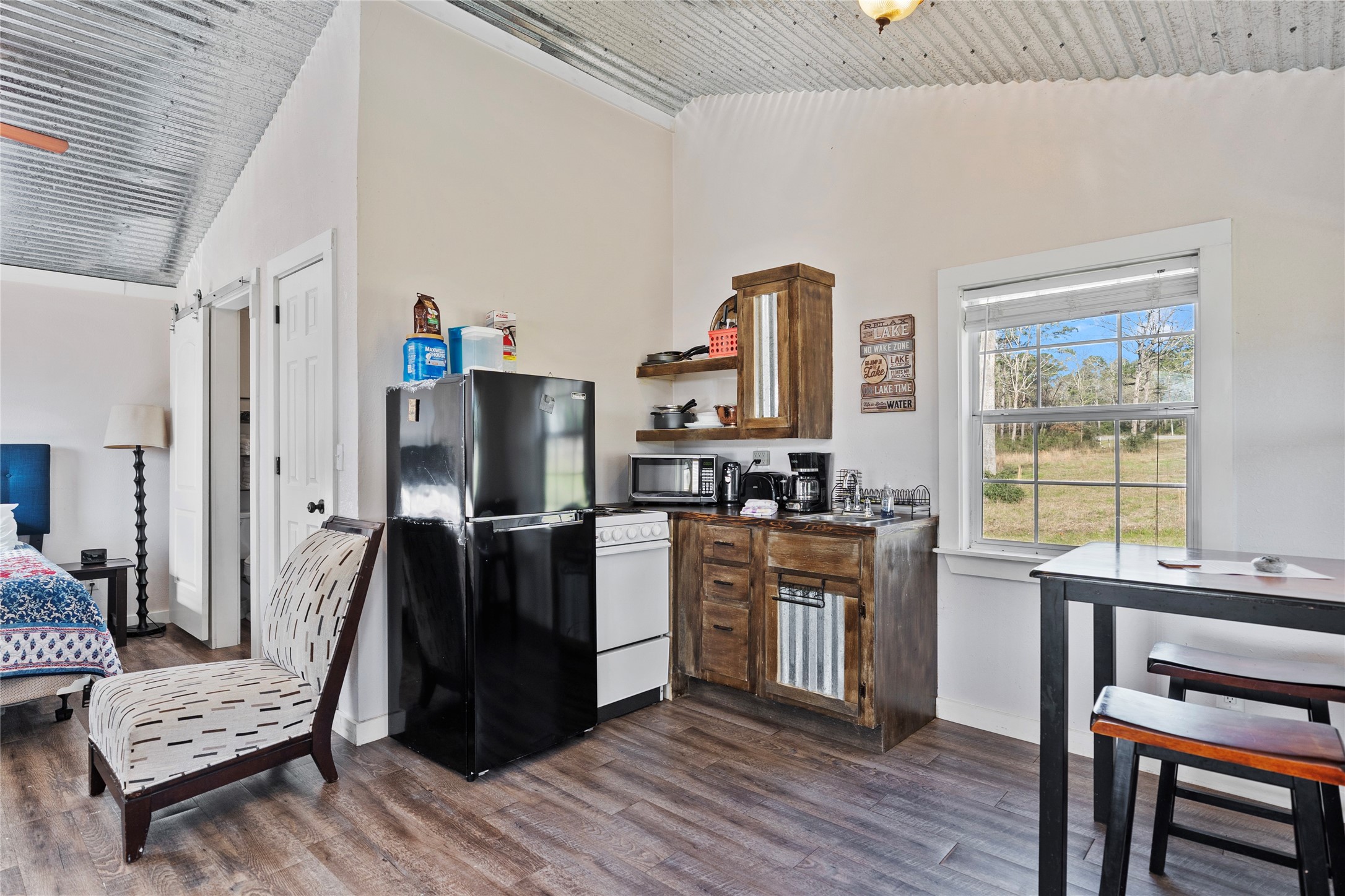 6776 Farm To Market Road 356 Trinity, TX 75862 - Photo 35 of 50 a kitchen with stainless steel appliances kitchen island wooden floors and wooden cabinets