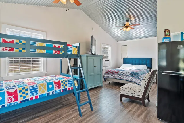 a bedroom with furniture and a wooden floor