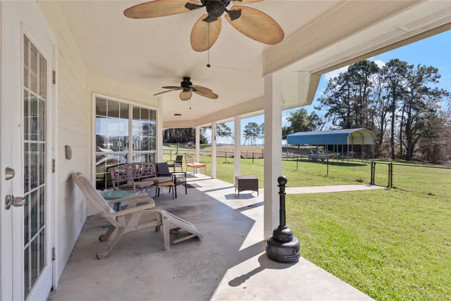 a view of a livingroom with furniture and floor to ceiling window