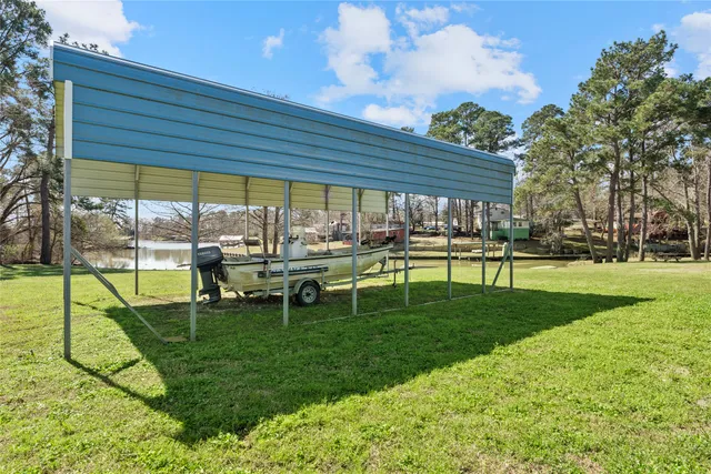 a view of a swimming pool with a patio and a yard