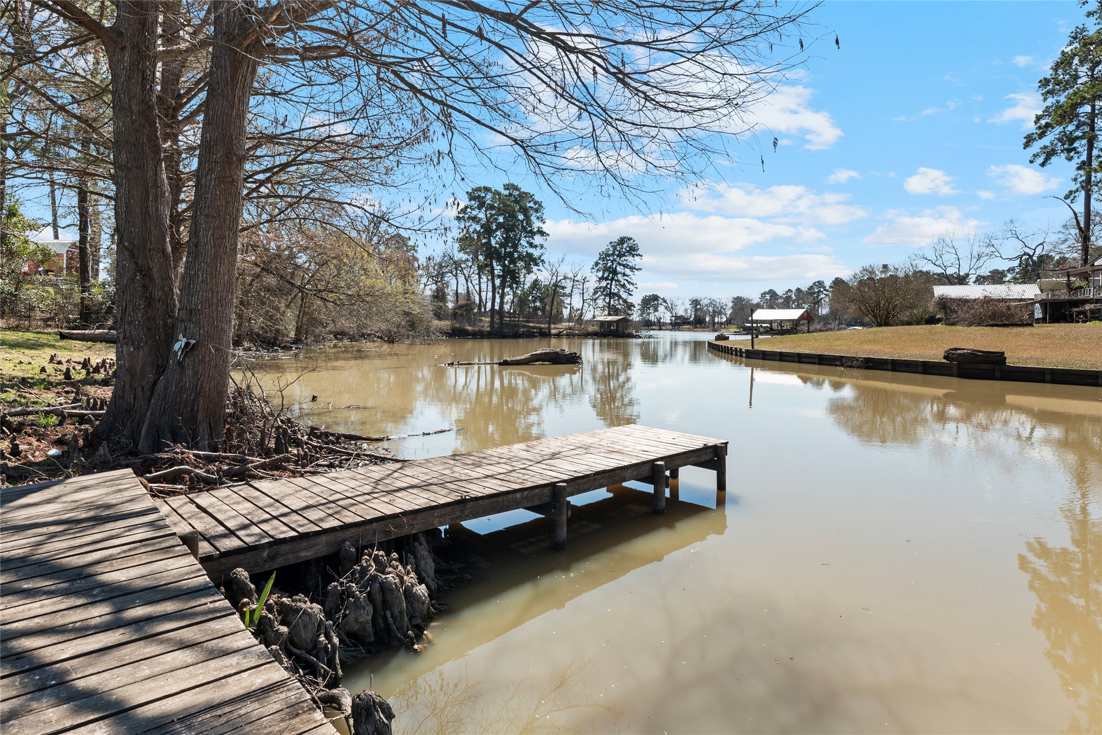 6776 Farm To Market Road 356 Trinity, TX 75862 - Photo 9 of 50 a view of a lake with wooden deck and trees