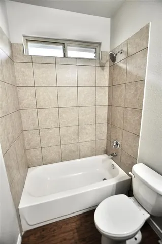 a bathroom with a bathtub and toilet