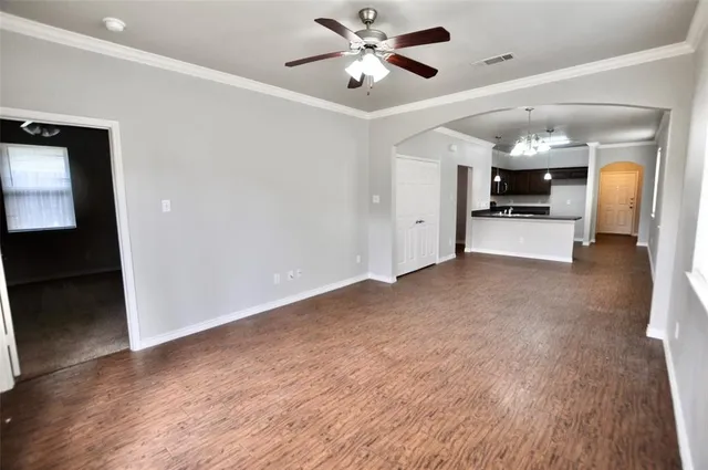 a view of empty room with kitchen and sink