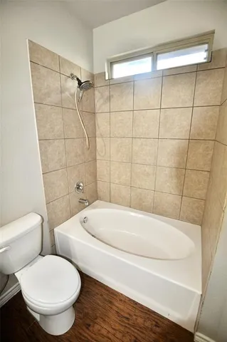 a bathroom with a toilet and a bathtub