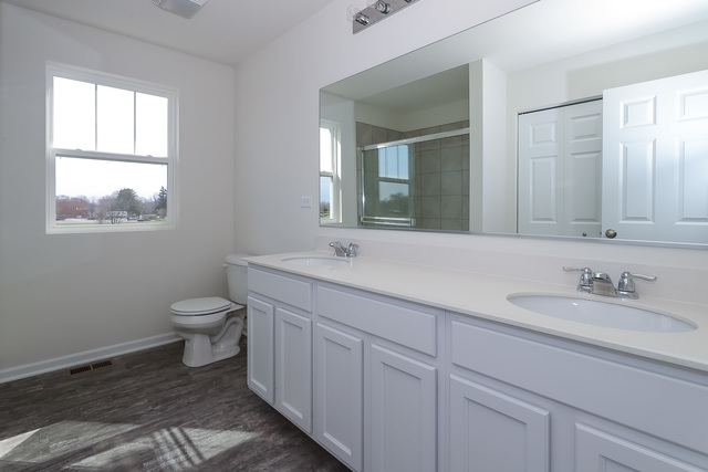 910 Mary, Unit 14 Marengo, IL 60152 - Photo 20 of 27 a bathroom with a toilet sink and mirror
