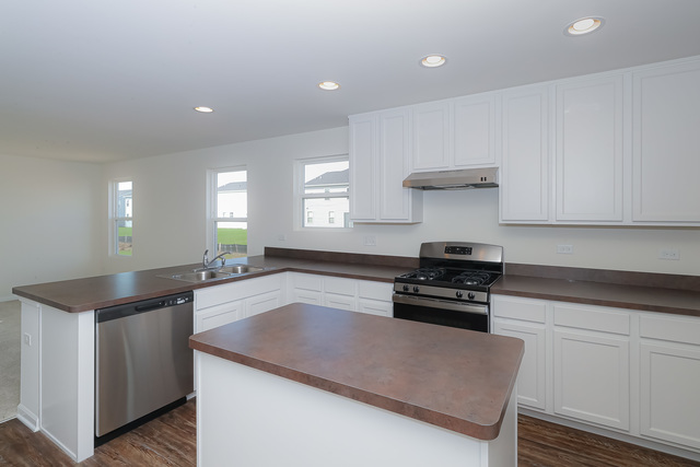 910 Mary, Unit 14 Marengo, IL 60152 - Photo 6 of 27 a kitchen with granite countertop a stove and a sink