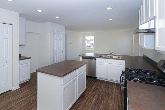910 Mary, Unit 14 Marengo, IL 60152 - Photo 7 of 27 a kitchen that has a sink and a stove in it