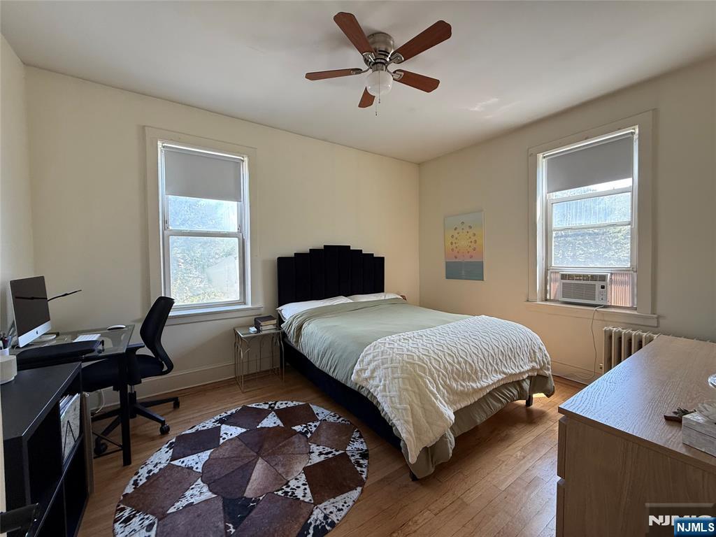 215 Orient Way, Unit C2 Rutherford, NJ 07070 - Photo 15 of 25 a bedroom with a bed and wooden floor