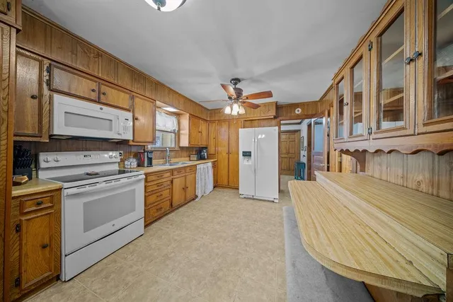 a kitchen with stainless steel appliances granite countertop a stove and a refrigerator