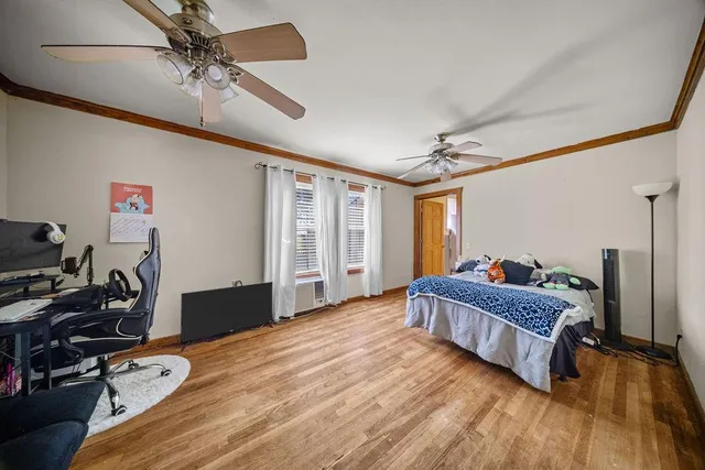 a room with a bed and wooden floor