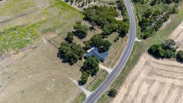 a view of a yard with wooden fence