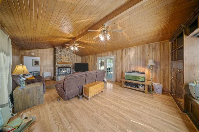 a living room with furniture a flat screen tv and a table