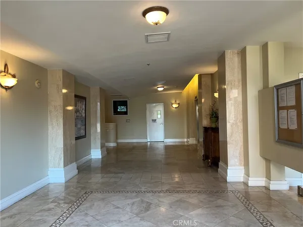a view of a hallway with wooden shelves