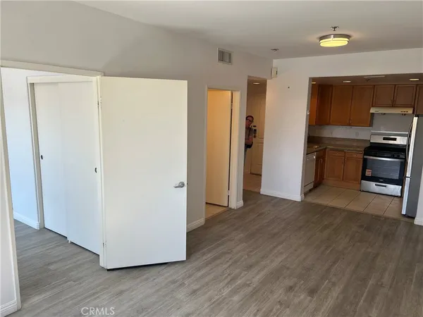 a view of a kitchen with a refrigerator a stove top oven