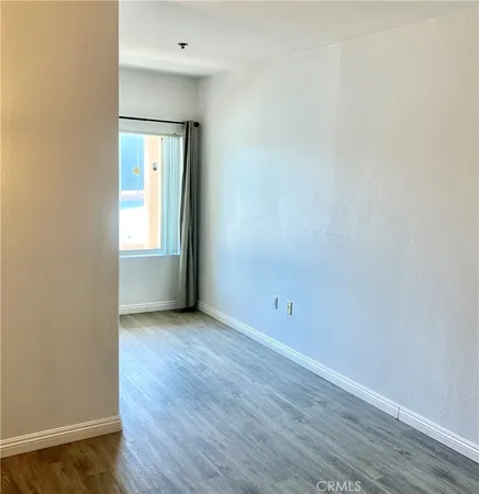 an empty room with wooden floor and closet