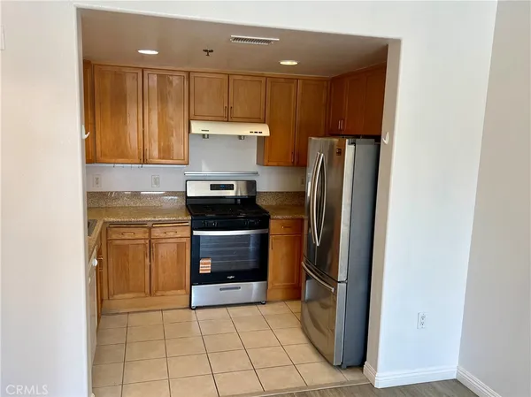 a kitchen with a refrigerator and a stove