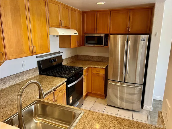 a kitchen with a refrigerator a stove and cabinets
