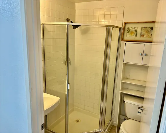 a bathroom with a shower and toilet