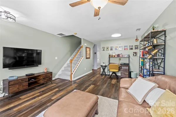 a living room with furniture and a flat screen tv