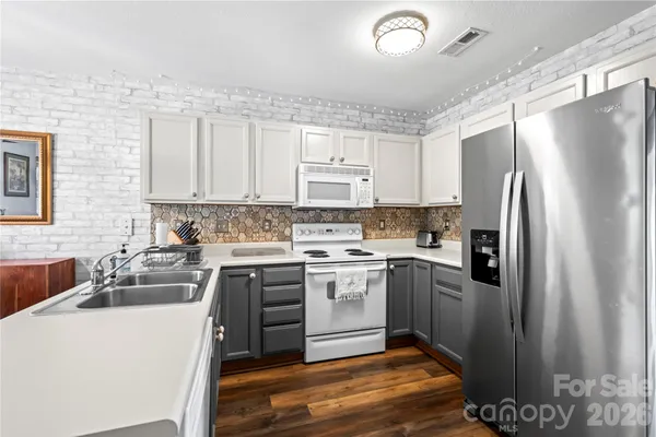 a kitchen with kitchen island a sink stainless steel appliances and cabinets