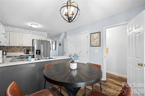 a dining room with furniture and wooden floor