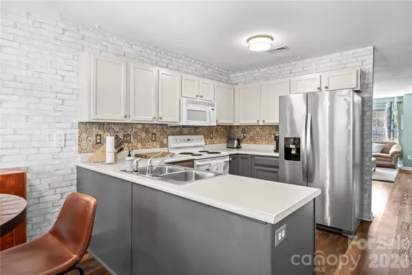 a kitchen with a sink a microwave a stove and refrigerator