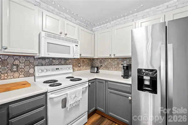 a kitchen with stainless steel appliances a stove a microwave and a refrigerator