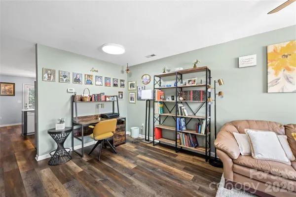 a view of a livingroom with furniture and hardwood floor