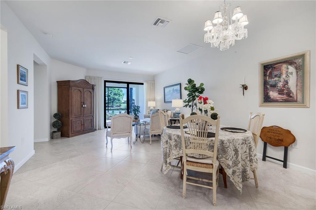 5948 Mayflower Way Ave Maria, FL 34142 - Photo 15 of 48 a view of a dining room with furniture and chandelier