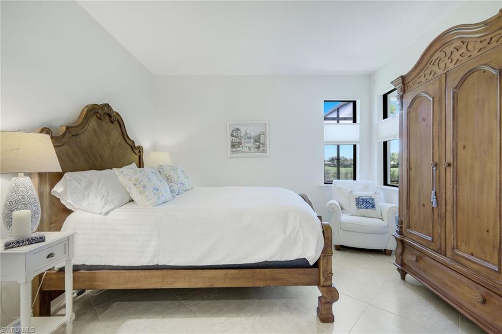5948 Mayflower Way Ave Maria, FL 34142 - Photo 17 of 48 a spacious bedroom with a bed and a couch