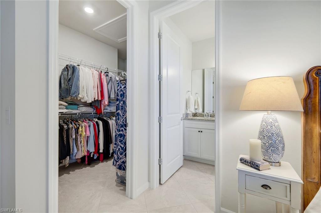 5948 Mayflower Way Ave Maria, FL 34142 - Photo 18 of 48 a view of walk in closet with clothes and shoes