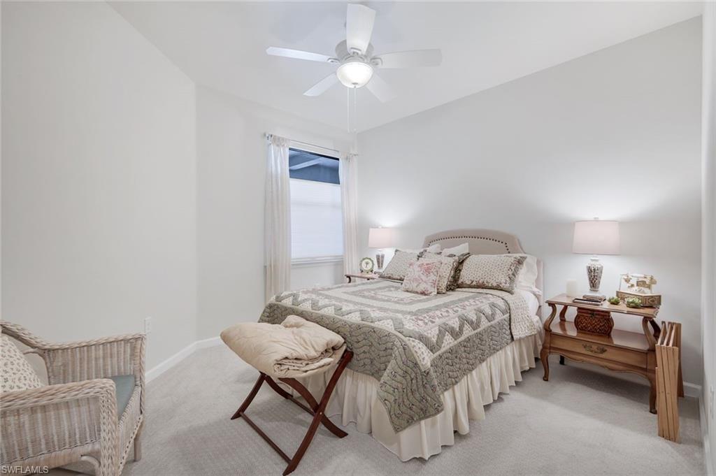 5948 Mayflower Way Ave Maria, FL 34142 - Photo 20 of 48 a bedroom with a bed and a chandelier