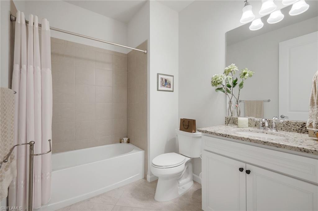 5948 Mayflower Way Ave Maria, FL 34142 - Photo 21 of 48 a bathroom with a granite countertop sink a toilet and shower