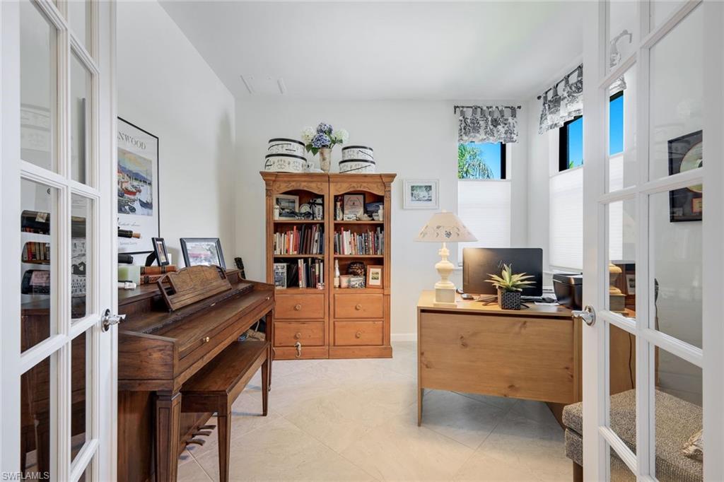 5948 Mayflower Way Ave Maria, FL 34142 - Photo 22 of 48 a reading room with furniture and book shelf