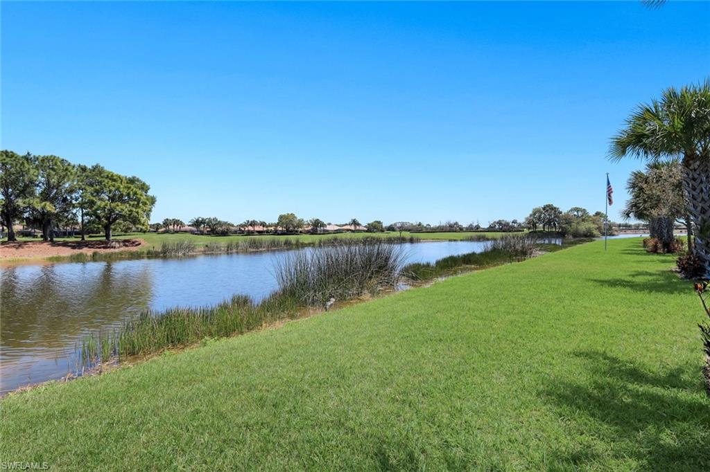 5948 Mayflower Way Ave Maria, FL 34142 - Photo 31 of 48 a view of a lake with houses in the back