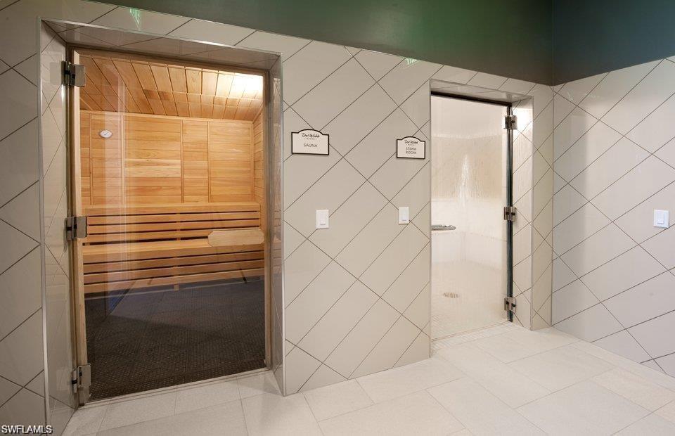 5948 Mayflower Way Ave Maria, FL 34142 - Photo 43 of 48 a bathroom with a shower and a glass door