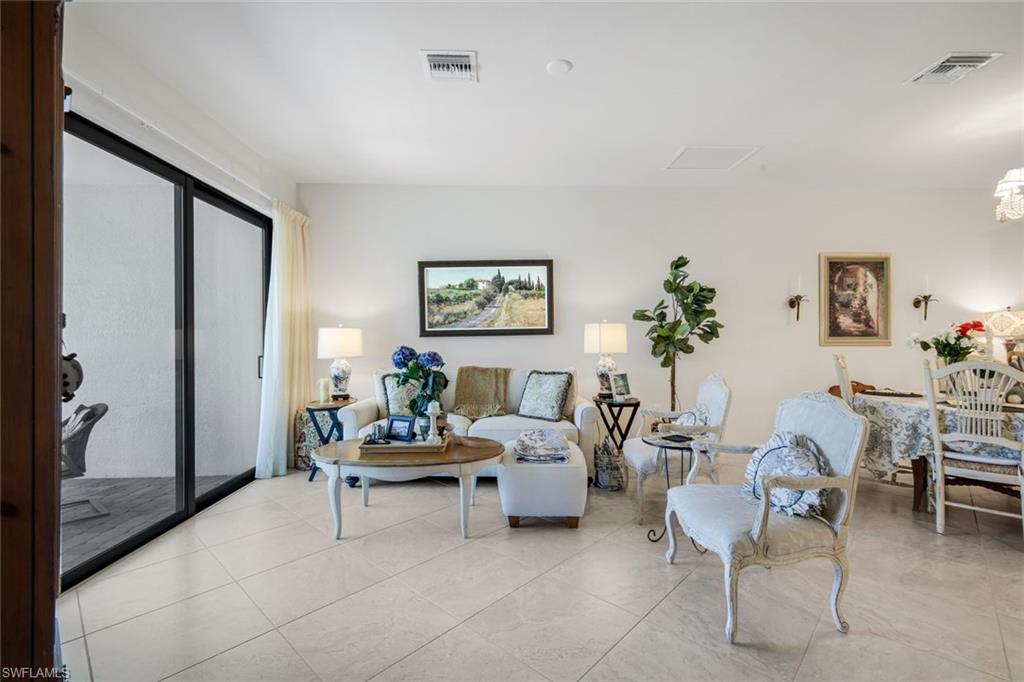 5948 Mayflower Way Ave Maria, FL 34142 - Photo 6 of 48 a living room with furniture and a potted plant