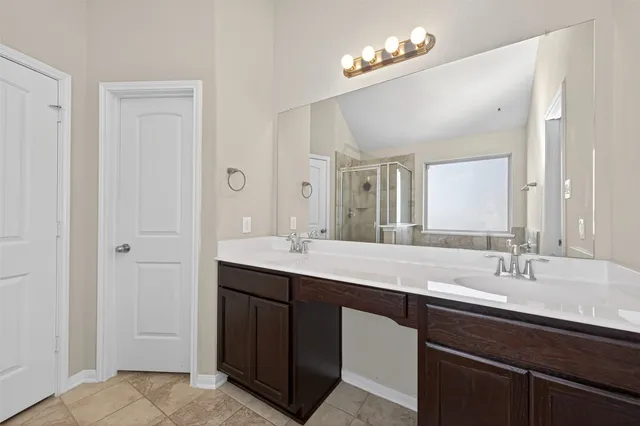 a living room with furniture a fireplace and a chandelier
