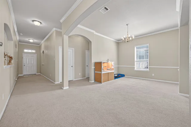 a view of a backyard with large trees and wooden fence